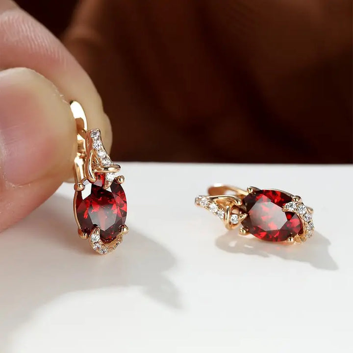 Elegant gold earrings with crimson pendants