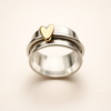 Silver ring with little gold heart