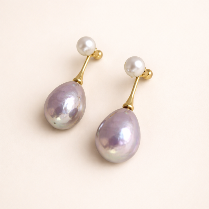 Elegant gold-colored earrings with lilac pearl