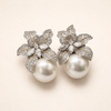 Elegant white gold pearl earrings with flower details