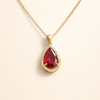 Elegant gold necklace with ruby drop pendant