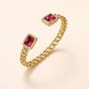 Elegant gold bracelet with a subtle ruby accent