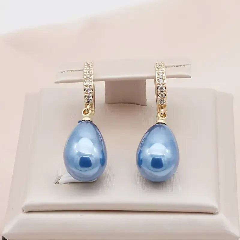Soft Waves gold-colored earrings with blue cubic zirconia